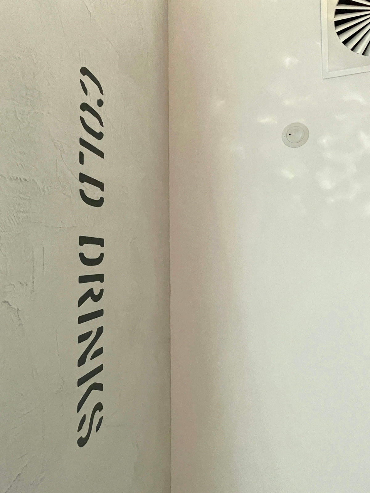 a white wall with black lettering on it