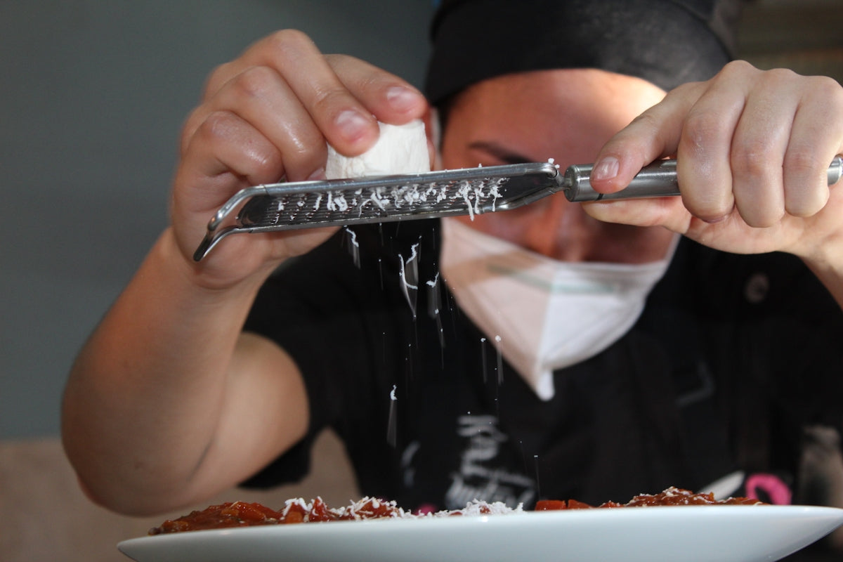 person holding stainless steel bread knife