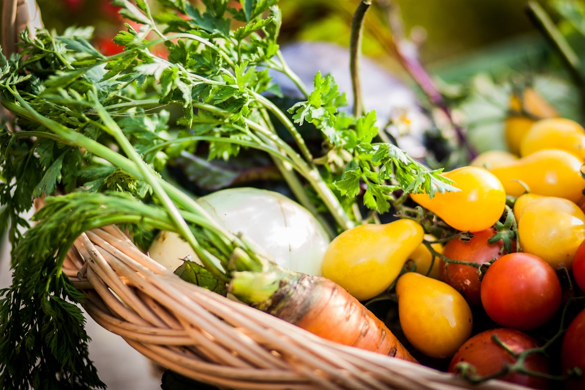 a basket filled with lots of different types of vegetables